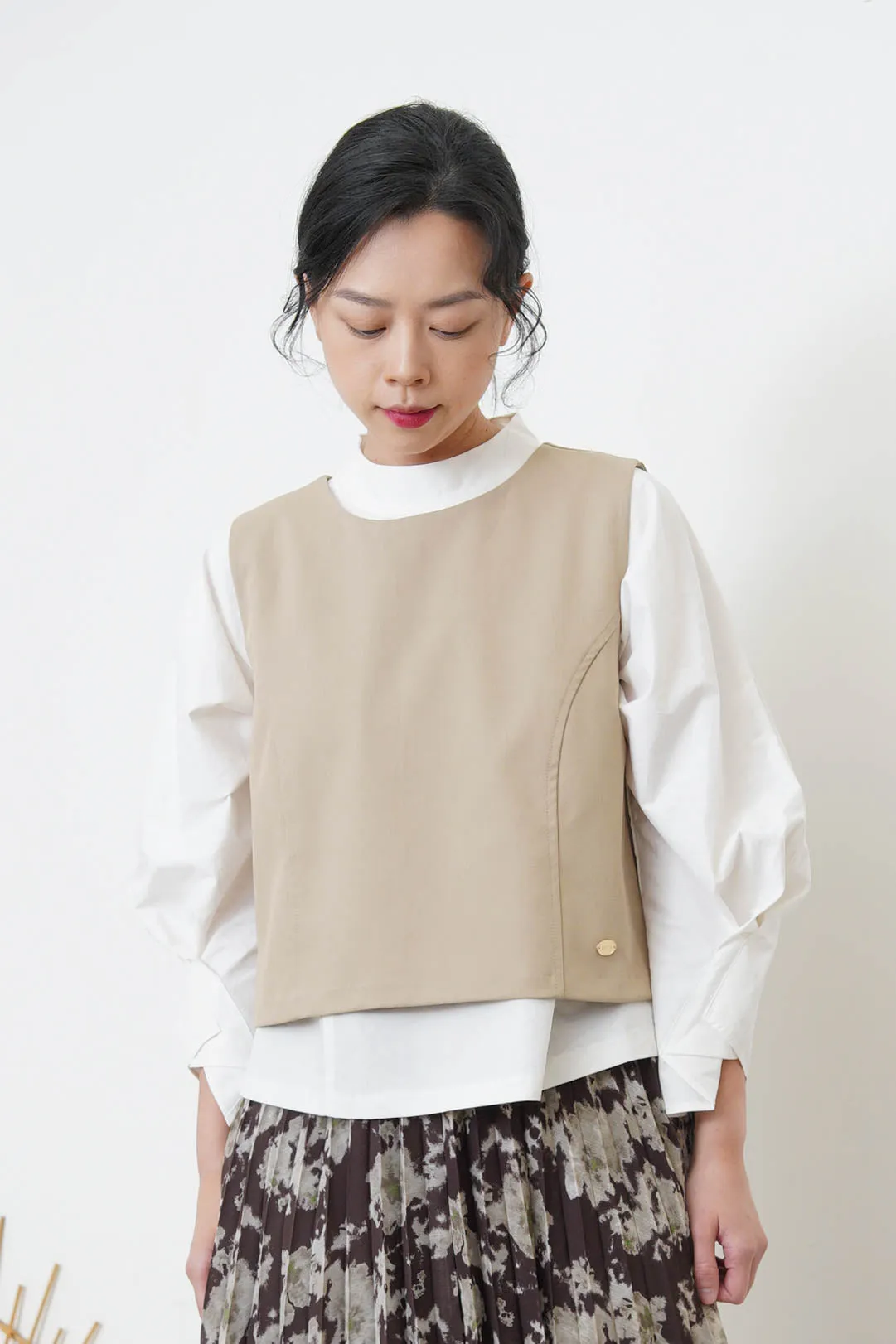 Beige vest w/ badge