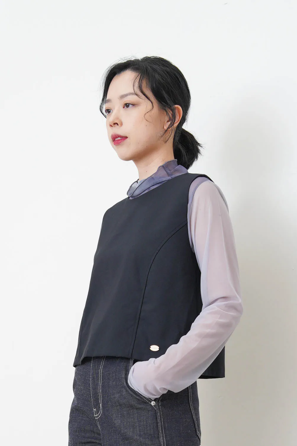 Beige vest w/ badge