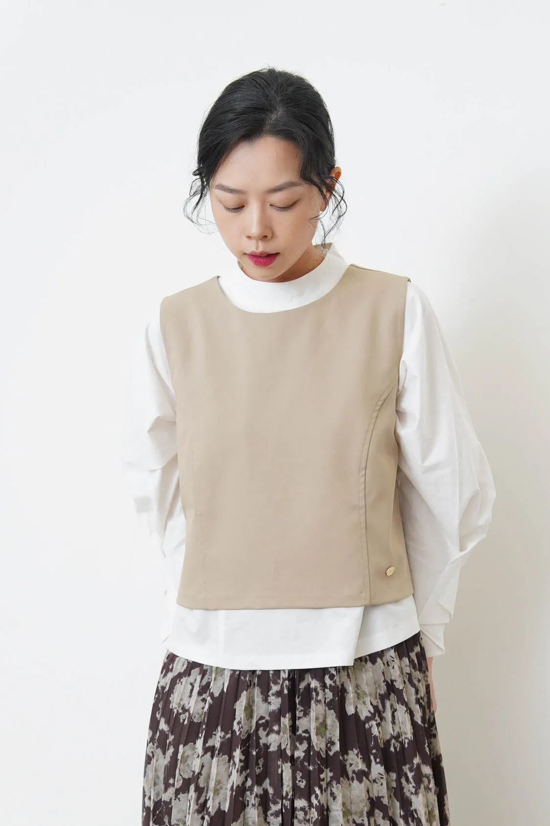 Beige vest w/ badge
